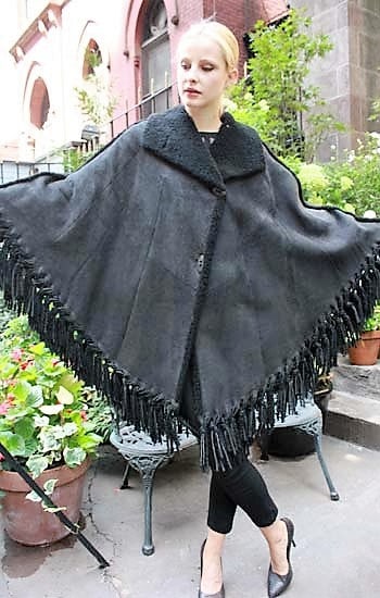 Marc Kaufman Furs Presents a charcoal gray shearling cape from Marc Kaufman Furs New York,Argentina,United Kingdom,Austria,Denmark,Norway,Australia,Finland,Saudi Arabia,Oman,Kuwait,Jordan,Egypt